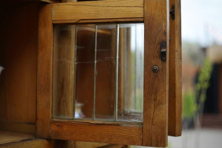 Close-up of a walnut display case with glass shelves
