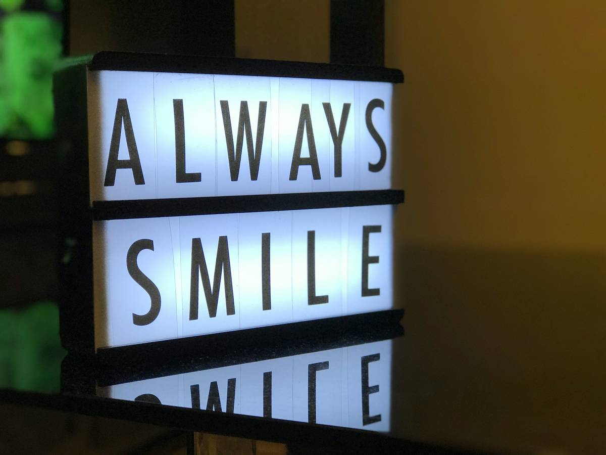 Custom-built display light box with layered diffusion showing vintage photographs under warm, even illumination